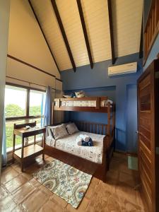 a bedroom with two bunk beds and a blue wall at Casa Corazón - Spacious 6 Bedroom Beachfront Villa with Pool Pier in Riversdale +24 photos