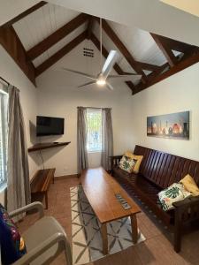 a living room with a couch and a table at Casa Corazón - Spacious 6 Bedroom Beachfront Villa with Pool Pier in Riversdale