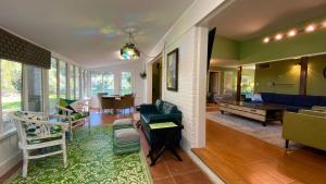a living room with a couch and a dining room at Cuddlefish in Jekyll Island