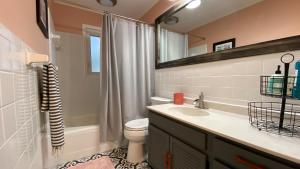 a bathroom with a sink and a toilet and a shower at Cuddlefish in Jekyll Island +29 photos