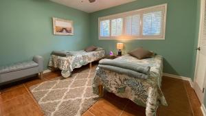 a room with two beds and a window at Cuddlefish in Jekyll Island