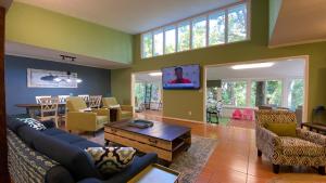 a living room filled with furniture and a flat screen tv at Cuddlefish in Jekyll Island