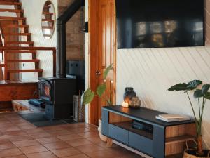 a living room with a stove and a table at Le Selby in Dunham +37 photos