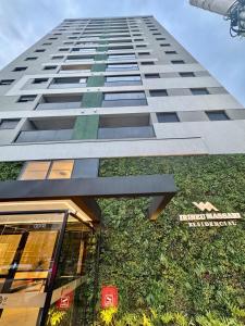 a tall building with grass on the side of it at 2-bedroom apartment, Home Office and panoramic view in São Carlos