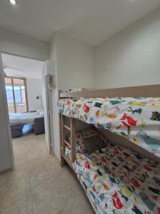 a bedroom with two bunk beds in a room at Cozy studio proche plages et gare in Sanary-sur-Mer