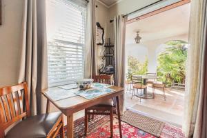 a dining room with a table and chairs and a large window at Serene Private Suite Patio Upscale Berkeley in Berkeley