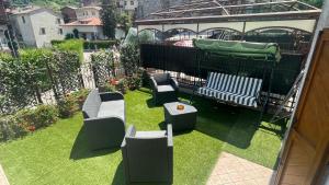 a garden with a gazebo with chairs and a playground at Casa Domi 