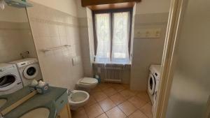 a bathroom with a toilet sink and a washing machine at Casa Domi  +11 photos