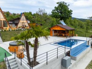 an image of a luxury home with a swimming pool and a house at Cabanele Adyana&Raysa in Seaca