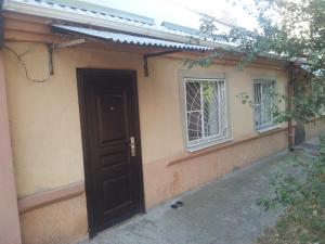 a house with a door and two windows at Квартира on Vlasova 23 in Pyatigorsk