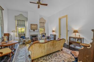 a living room with a couch and a fireplace at The Manor - Historic Mansion, Wifi, Covered Porch, Screen Porch, King Bed, Walk to Spas, Shops & Restaurants in Berkeley Springs