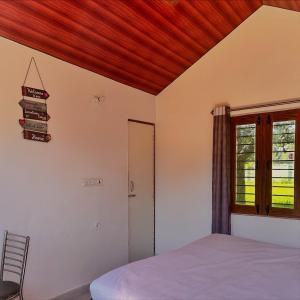 Ένα ή περισσότερα κρεβάτια σε δωμάτιο στο The Kumaoni Homestay