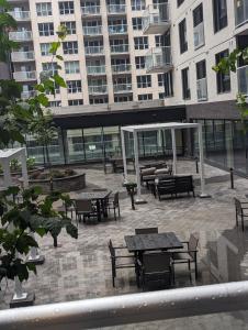 a courtyard with tables and chairs in a building at Modern Condo in Ottawa Downtown in Ottawa