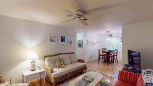 a living room with a couch and a table at Beachbreak in Jekyll Island