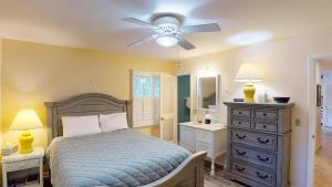 a bedroom with a bed and a ceiling fan at Beachbreak in Jekyll Island