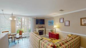 a living room with a couch and a fireplace at Villa 326 - A SHORE THING in Jekyll Island