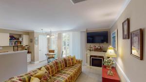 a living room with a couch and a fireplace at Villa 326 - A SHORE THING in Jekyll Island +4 photos