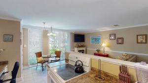 a kitchen and living room with a tea kettle at Villa 326 - A SHORE THING in Jekyll Island