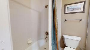 a bathroom with a toilet and a tub and a sink at Villa 326 - A SHORE THING in Jekyll Island