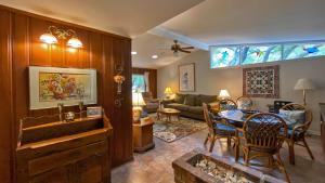 a living room with a couch and a table with chairs at Very Nice Cottage in Jekyll Island