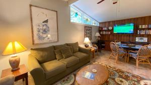 a living room with a couch and a table at Very Nice Cottage in Jekyll Island