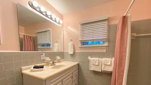 a bathroom with a sink and a mirror at Very Nice Cottage in Jekyll Island +20 photos