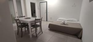 a bedroom with a bed and a desk and a table at sosta modicana in Modica +6 photos