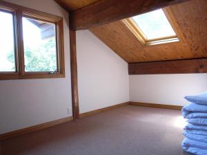 an attic room with two windows and a mattress at Cottage All Resort Service / Vacation STAY 8419 in Inawashiro