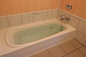a bath tub filled with water in a bathroom at Cottage All Resort Service / Vacation STAY 8419 in Inawashiro