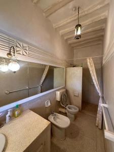 a bathroom with a toilet and a sink and a mirror at Villa Elizabeth by the Golf Club in Malindi +20 photos