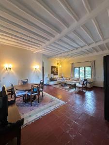 a large living room with a table and chairs at Villa Elizabeth in Malindi