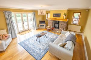 a living room with a couch and a fireplace at Waun Yscir Rural escape in the Brecon Beacons in Brecon