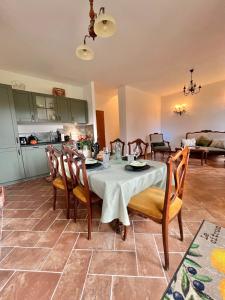 a kitchen and dining room with a table and chairs at LA COLLINA DEI SAPORI Montepulciano in Montepulciano