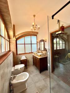 a bathroom with a toilet and a sink and a mirror at LA COLLINA DEI SAPORI Montepulciano in Montepulciano