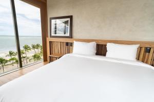 Postel nebo postele na pokoji v ubytování Sais Beach Living Hotel