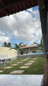 a park with a bench in front of a building at Espaço para Eventos e Temporadas em in Paracuru +9 photos