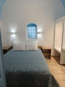 a bedroom with a bed and a window on the wall at Odysseas Traditional house in Mesaria