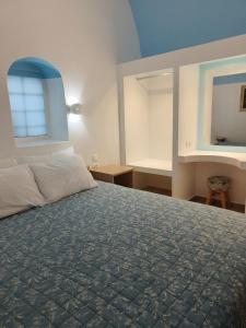a bedroom with a large bed with a blue ceiling at Odysseas Traditional house in Mesaria