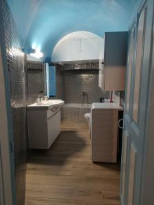 a bathroom with two sinks and a toilet at Odysseas Traditional house in Mesaria