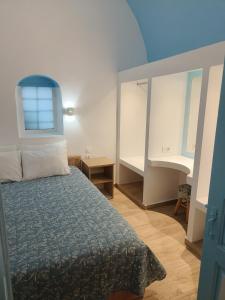 a bedroom with a bed and a window at Odysseas Traditional house in Mesaria