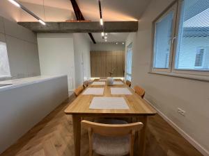 ein Esszimmer mit einem Holztisch und Stühlen in der Unterkunft Goldhammer Premium Apartments in Tarnów