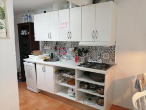 a kitchen with white cabinets and a stove at Bett 2 im Männer 4-Bettzimmer NUR Männer ONLY men SOLO hombres in Mogán +8 photos