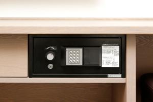 a microwave oven sitting on top of a shelf at Dormy Inn Nagano in Nagano