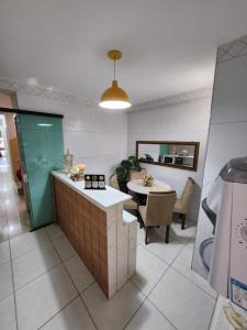 a kitchen with a table and a dining room at Eds pousada in Juazeiro do Norte