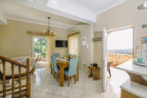 a kitchen and dining room with a table and chairs at Creta Sea View 2BR Maisonette by ΜΡS in Marathokefála