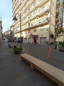 a wooden bench sitting in front of a building at Le Antiche Volte suite in Agropoli