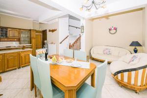 a kitchen and dining room with a wooden table and chairs at Creta Sea View 2BR Maisonette by ΜΡS in Marathokefála