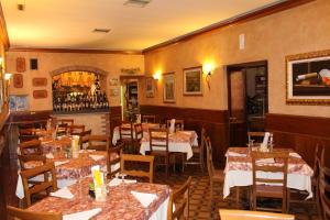 a restaurant with tables and chairs and a fireplace at Casa Domi 