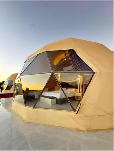 a tent with a room in the middle at MIRNA lUXURY CAMP in Wadi Rum