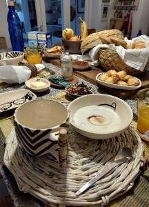 a table with plates and bowls of food on it at Casa Ecléctica in Santiago del Estero